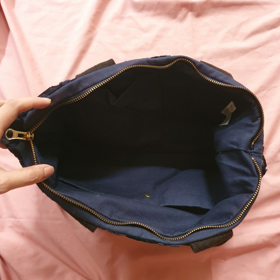 Dark Blue Textured Tote Bag with Zipper (Category: Tote Bags) located in Paranaque City. Submitted by cobien (Listing ID 1463461514, Image 3). Description: - Stylish dark blue tote bag - Features a textured chevron pattern - Secure zip closure YKK zip - Sturdy handle for comfortable carrying - Lined with navy blue fabric - Ideal for everyday errands or travel adventures.