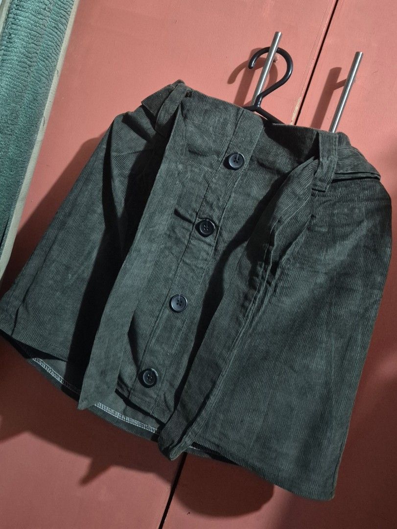 Dark Green Corduroy Button-Up Skirt (Category: Skirts) located in Imus. Submitted by shopestepanimey (Listing ID 1463430541, Image 1). Description: - Tag removed but never worn - Can fit xsmall to small only - Dark green corduroy fabric - Button-up front with four buttons - Belt loop detail at the waist - Ribbed texture for a classic look - Mini skirt length - Ideal for casual outfits.