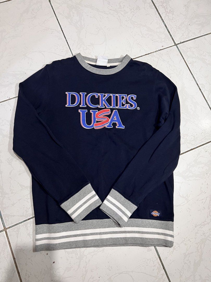 Dickies USA Navy Blue Sweatshirt (Category: Coats, Jackets and Outerwear) located in Talisay. Submitted by maxiesgarments (Listing ID 1463495304, Image 1). Description: - Navy blue sweatshirt with 'Dickies USA' graphic - Grey collar for a classic look - Striped cuffs and hem add a sporty touch - Small Dickies logo tag on the side - Perfect for comfortable, casual wear.