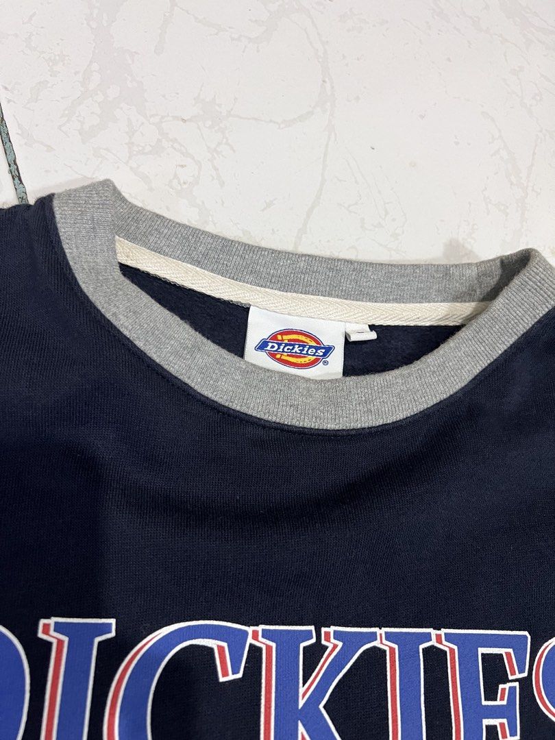 Dickies USA Navy Blue Sweatshirt (Category: Coats, Jackets and Outerwear) located in Talisay. Submitted by maxiesgarments (Listing ID 1463495304, Image 2). Description: - Navy blue sweatshirt with 'Dickies USA' graphic - Grey collar for a classic look - Striped cuffs and hem add a sporty touch - Small Dickies logo tag on the side - Perfect for comfortable, casual wear.
