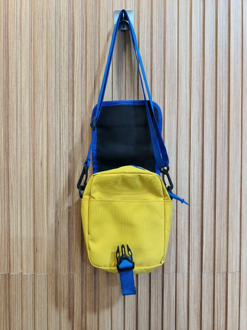 Dickies Yellow Blue Crossbody Bag (Category: Cross-body Bags) located in Mati. Submitted by Hylestuffs (Listing ID 1463409854, Image 2). Description: - Bright yellow crossbody bag with stylish blue trim. - Main compartment with secure zipper closure. - Convenient front zipper pocket for quick access. - Adjustable strap for a comfortable, customized fit. - Features a small, classic Dickies logo patch on the front. - Ideal for everyday errands, tra