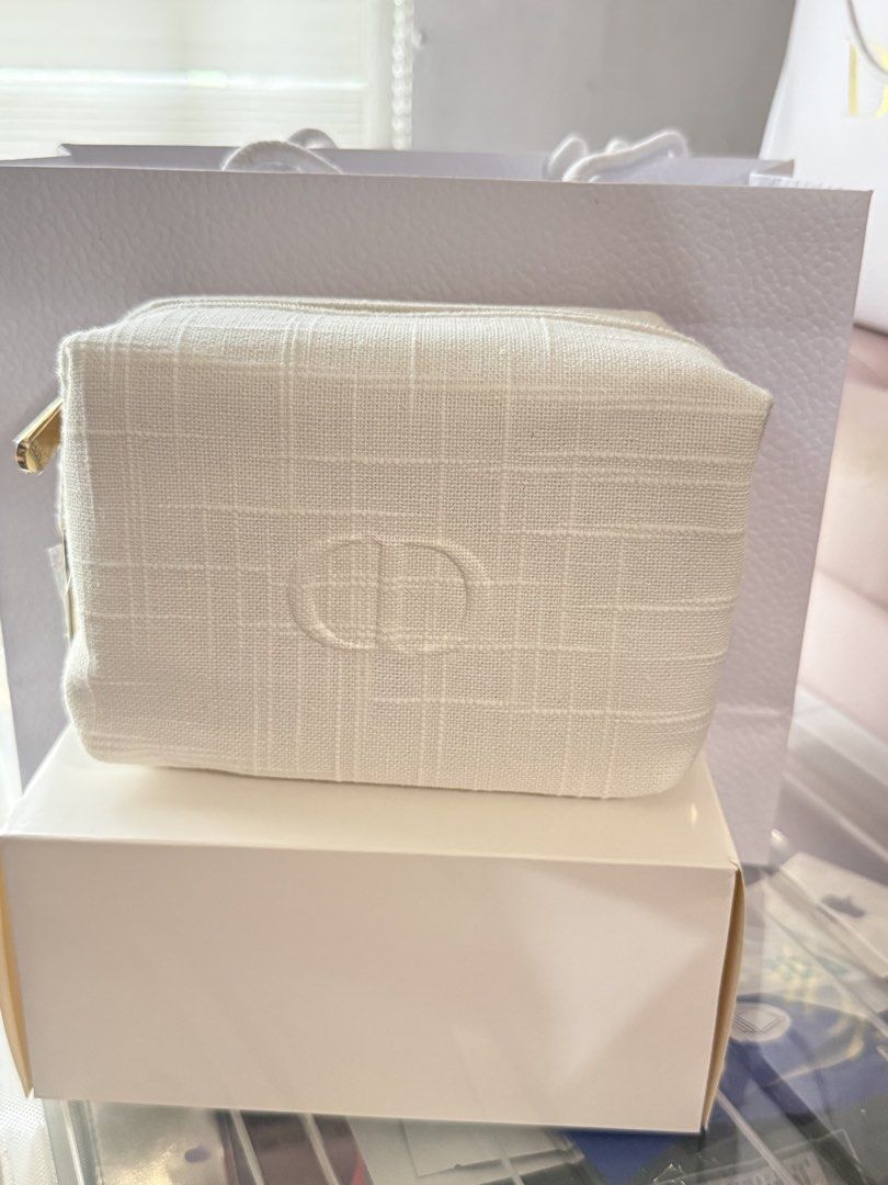 Dior Cosmetic Bag White Pouch (Category: Luxury Bags & Wallets) located in Manila. Submitted by hellomrys (Listing ID 1462842937, Image 1). Description: With box and paper bag.