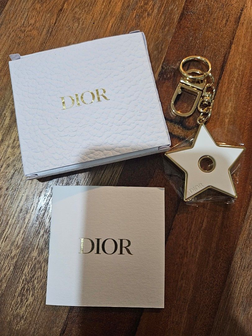 Dior perfumable keychain (Category: Other Accessories) located in Los Banos. Submitted by acleancloset (Listing ID 1463335343, Image 1). Description: pls see photos approx 2 inch ceramic star, total 4 inches including keyring.