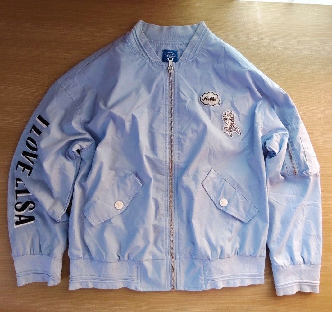 Disney Frozen Elsa & Anna Bomber Jacket (Category: Babies & Kids Fashion) located in Caloocan City. Submitted by luckybunny_8888 (Listing ID 1463346026, Image 1). Description: - Light blue bomber jacket featuring Disney's Frozen characters Elsa and Anna. - 'I LOVE ELSA' text detail on the sleeve. - 'Beautiful Sisters' text detail on the back. - Zip-up front closure. - Two functional pockets. - Ideal for any fan of the movie Frozen..