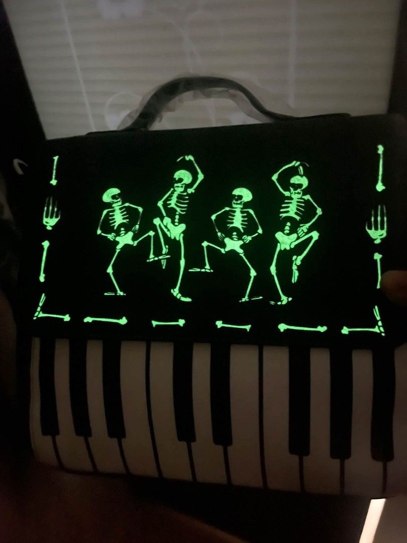 Disney Skeleton Piano Crossbody Bag (Category: Cross-body Bags) located in Pasig City. Submitted by janalopez904 (Listing ID 1462863996, Image 3). Description: -Glow in the dark - Unique Disney bag featuring a skeleton and piano design. - Classic black with stylish white accents. - Comes with a comfortable top handle. - Includes a detachable crossbody strap for versatile carrying. - Ideal for Halloween or adding a touch of fun to any outfit. - St