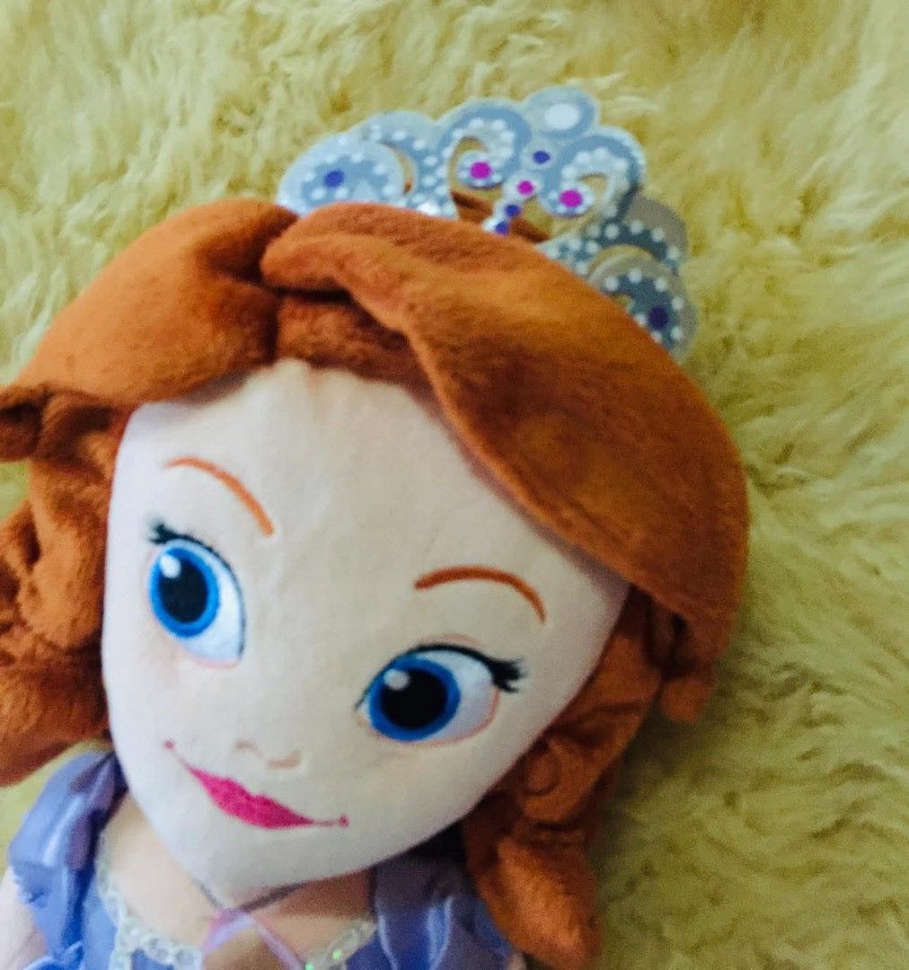 Disney Sofia the First Junior Series (Category: Plushies & Soft Toys) located in Baguio. Submitted by izza_thrifty (Listing ID 1463549979, Image 2). Description: - Sofia the First plush doll - Wears signature purple ballgown - Includes a small tiara - Approximately 18 inches tall - Ideal for any Sofia the First fan.