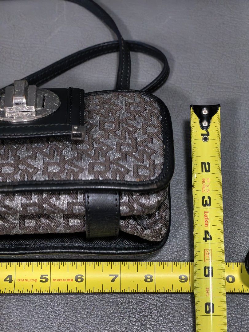 DKNY Monogram Crossbody Bag with Silver Clasp (Category: Cross-body Bags) located in Cagayan de Oro. Submitted by pootx (Listing ID 1463485135, Image 2). Description: - Authentic DKNY crossbody bag - Classic DKNY monogram pattern - Black leather trim - Secure silver turn-lock closure - Multiple interior compartments for organization - Adjustable strap for comfortable wear - Ideal for everyday use.