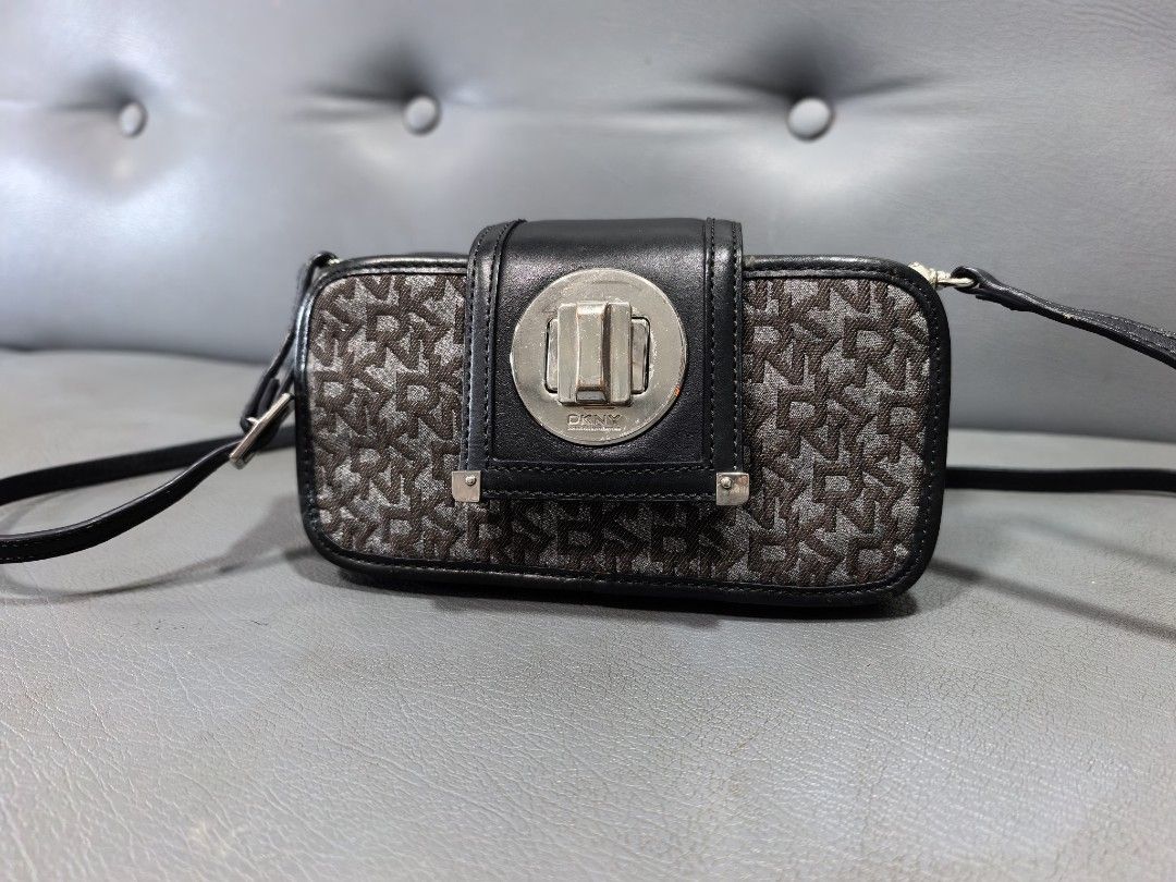 DKNY Monogram Crossbody Bag with Silver Clasp (Category: Cross-body Bags) located in Cagayan de Oro. Submitted by pootx (Listing ID 1463485135, Image 1). Description: - Authentic DKNY crossbody bag - Classic DKNY monogram pattern - Black leather trim - Secure silver turn-lock closure - Multiple interior compartments for organization - Adjustable strap for comfortable wear - Ideal for everyday use.
