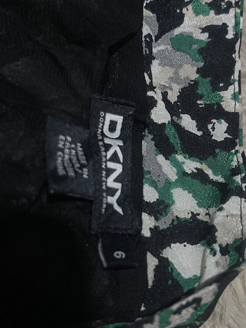 DKNY silk Bomber Jacket - Camo Print with Herringbone Sleeves (Category: Longsleeves) located in Donsol. Submitted by saksthriftavenuebyluckymaria8 (Listing ID 1463454551, Image 3). Description: - Cool DKNY bomber jacket - Unique camouflage print on body - Contrasting dark green herringbone sleeves - Zipper closure - Size 6 - Perfect statement piece for your wardrobe DKNY Silk zipper collarless top Sz 6 chest 22in armhole 9.5 in shoulder 17in len