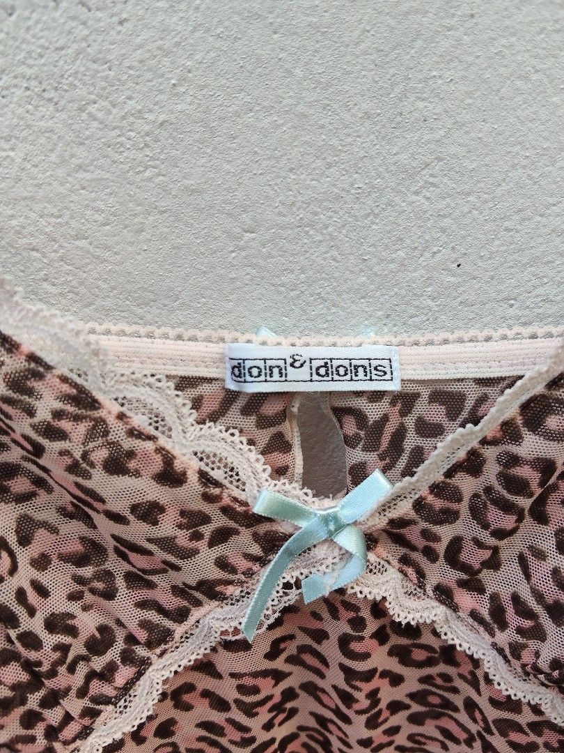 Don & Dons Leopard Print Mesh Slip Dress (Category: Dresses) located in City of Isabela. Submitted by jasheverything (Listing ID 1463365514, Image 3). Description: - Cute leopard print mesh slip dress - Features delicate lace trim - Adorned with a small blue bow at the bust - Adjustable spaghetti straps for a perfect fit - Sheer material, ideal for layering or as a standalone statement piece Excellent Condition S to M 650+SF.