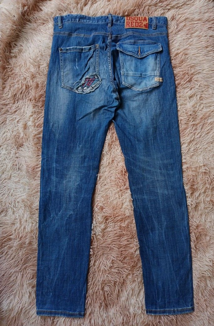 DSQUARED2 Red Tag Distressed Blue Denim Jeans Size 34 (Category: Jeans) located in Boston. Submitted by johnpaulvi30029 (Listing ID 1463403691, Image 2). Description: - DSQUARED2 Blue Denim Jeans - Size: 34 - Style: Distressed with rips and fading - Closure: Button fly - Origin: Made in Italy - Condition: Please check photos for all details.
