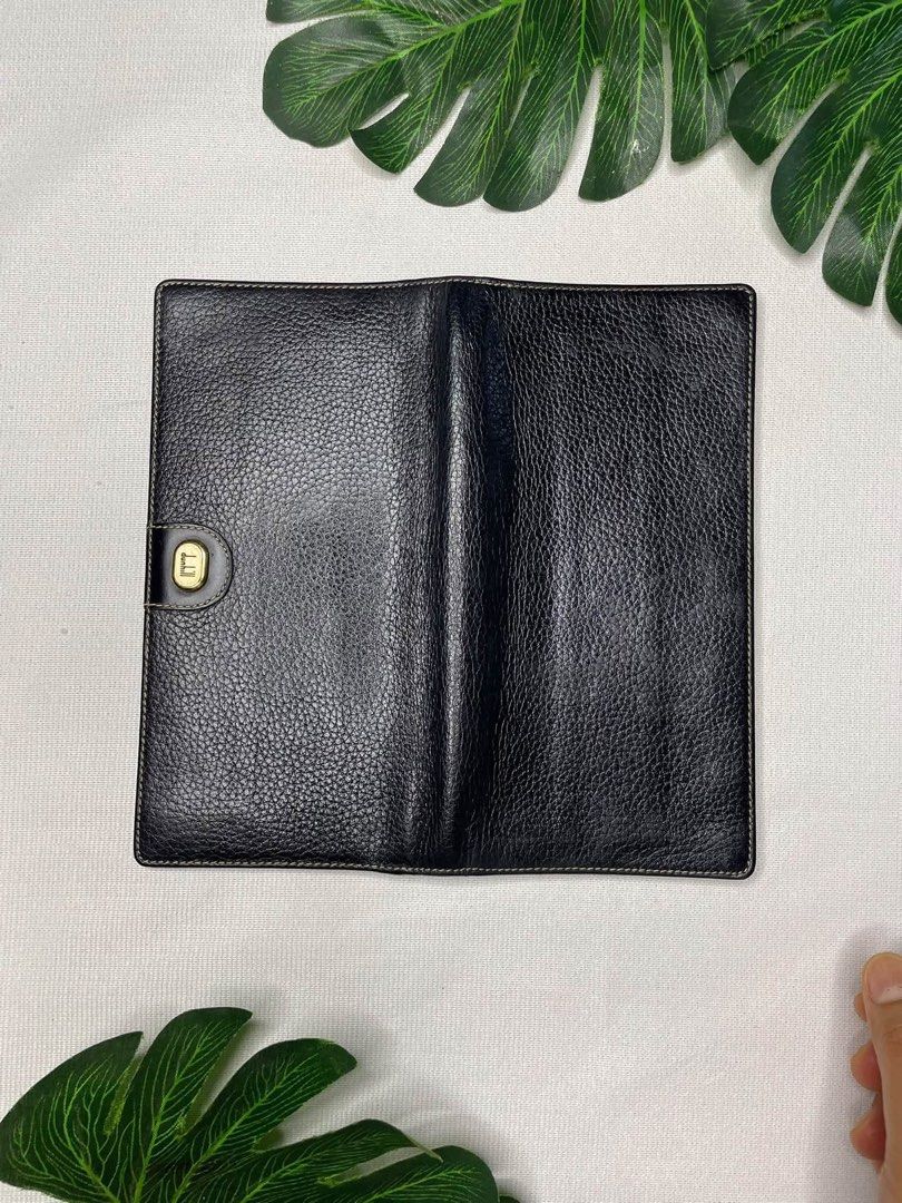 Dunhill Black Leather Long Wallet (Category: Luxury Bags & Wallets) located in Placer. Submitted by talaalond61563 (Listing ID 1463356300, Image 2). Description: - Classic black leather long wallet from Dunhill - Features a sophisticated pebble grain texture on the outside - Interior includes multiple card slots and a clear ID window for easy access - Elegant gold-tone hardware detailing - Ideal for keeping your essentials neatly organized.