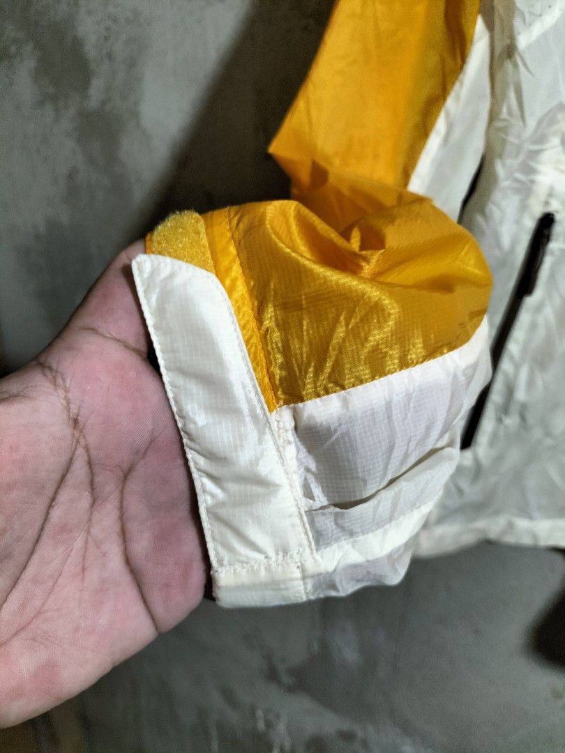 Eider Yellow White Hooded Windbreaker Jacket (Category: Coats, Jackets and Outerwear) located in Valencia. Submitted by cabisaythriftshop (Listing ID 1463420649, Image 2). Description: - Eider Windbreaker Jacket - Size: XL - Color: Bright Yellow & White - Features: Hood, Zippered Pockets - Material: Lightweight - Ideal for: Outdoor activities - Condition: Please check photos for details.