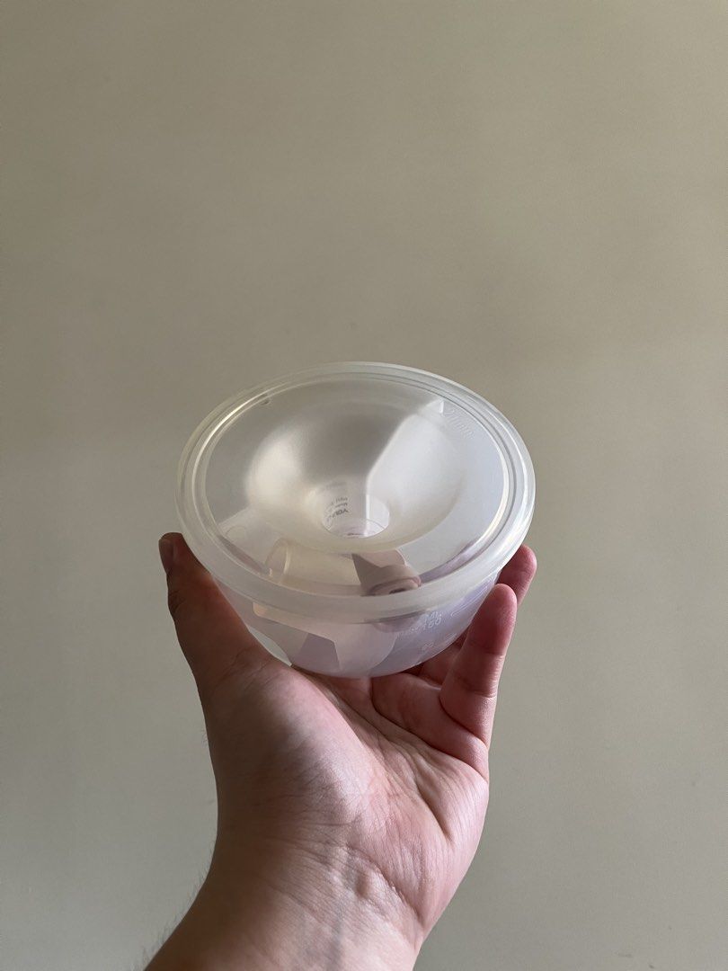 Electric Breast Pump Flange Set (Category: Breastfeeding & Bottle Feeding) located in Quezon City. Submitted by dianeecanlas (Listing ID 1463393187, Image 2). Description: - Set of electric breast pump flanges - Color: White and clear plastic - Includes main flange and clear silicone insert - Features side buttons for power and intensity adjustment - Cleaned and ready for a new owner.