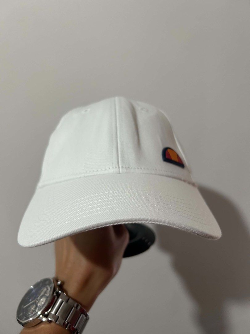 Ellesse White Cap (Category: Caps & Hats) located in Manila. Submitted by itsprincessm (Listing ID 1463495585, Image 1). Description: - Classic white Ellesse cap - Features iconic Ellesse logo on the front - Adjustable strap at the back for a comfortable fit - Ideal for everyday wear or sports - Simple and stylish design.