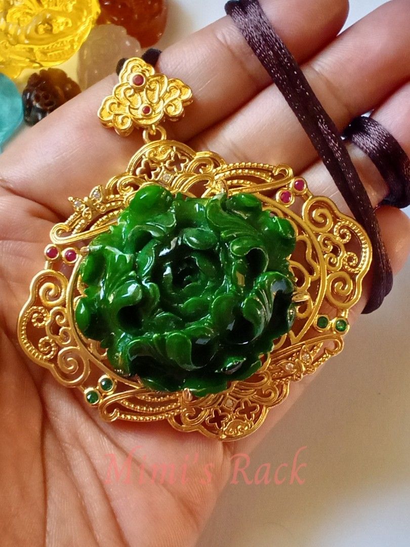 Emerald Jade Peony Carving Ruby Accent Rope Necklace (Category: Necklaces) located in Taguig. Submitted by mimisrack (Listing ID 1463331165, Image 1). Description: 💚A stunning emerald jade peony carving featuring an intricately detailed floral design with a rich, glossy green finish. The centerpiece is beautifully framed in an ornate gold-tone filigree setting, accented with ruby stones that show a lovely pink-red fluorescence under UV light. ✨ 