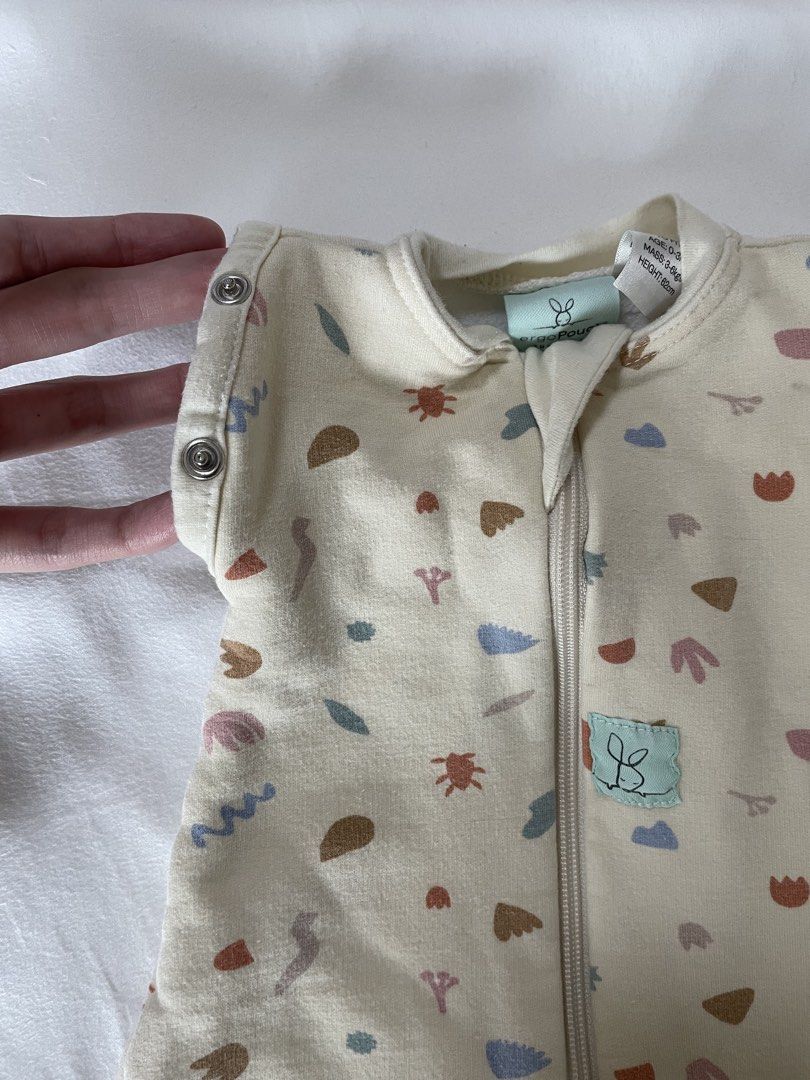 Ergopouch baby Transition swaddle Bag (Category: Babies & Kids Fashion) located in Pasig City. Submitted by ourpreloved.shop (Listing ID 1463373069, Image 2). Description: - ergopouch transition sleep swaddle - Size: Small - Design: Cute abstract pattern with shapes and flowers in cream, pink, blue, and brown - Closure: Zipper down the front - Feature: Detachable arms to transition from swaddle to sleep sack - Benefit: Ideal for babies learning t