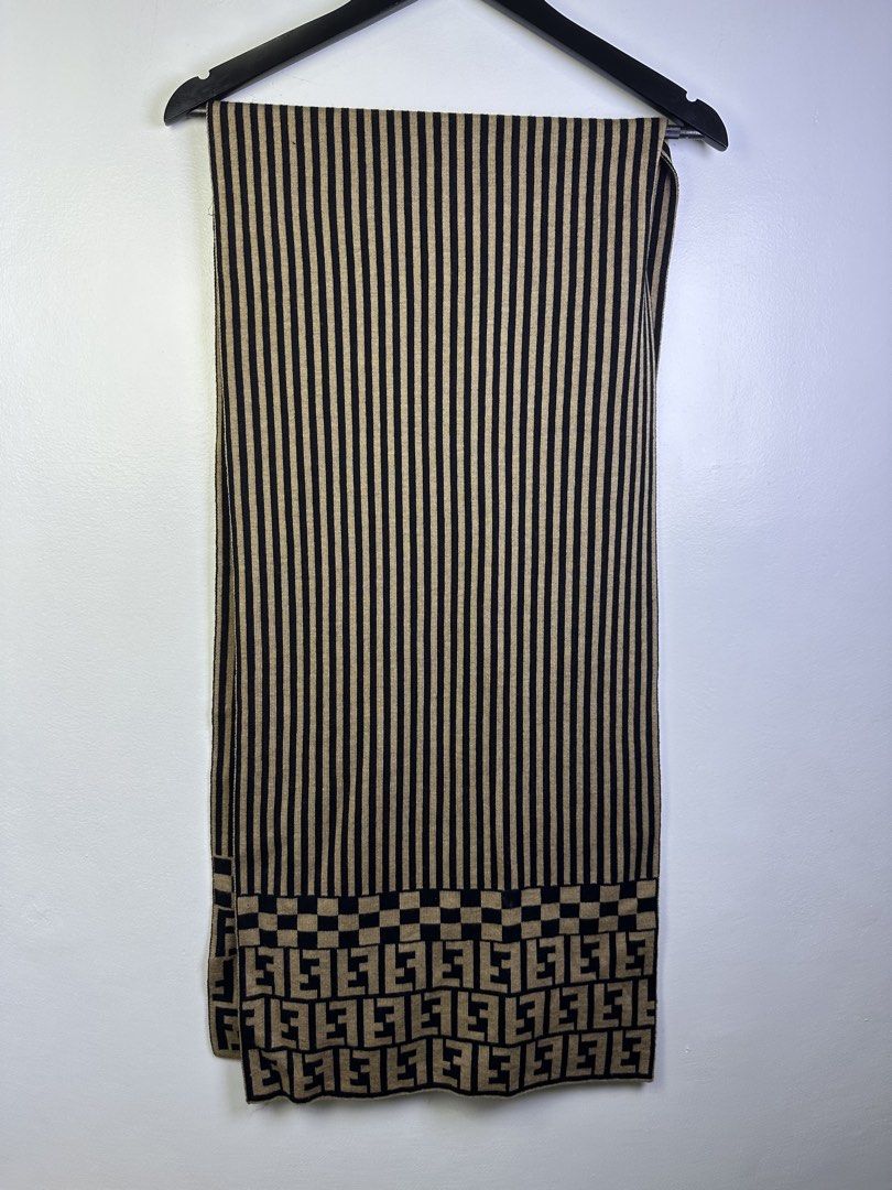 Fendi Striped Scarf with FF Logo (Category: Scarves) located in Manila. Submitted by declutterpromax (Listing ID 1463407531, Image 2). Description: - Fendi scarf - Iconic FF logo pattern at hem - Classic beige and black stripes - Soft knit material for comfort - Versatile designer accessory - Approximate dimensions: 15.5 x 64 inches.