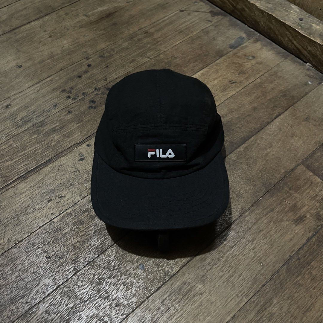 Fila Black 5-Panel Cap (Category: Caps & Hats) located in Manila. Submitted by bravebird_164362 (Listing ID 1463451872, Image 1). Description: - Classic black 5-panel cap - Features iconic Fila logo patch on the front - Adjustable strap at the back for a comfortable fit - Simple and versatile design - Great for everyday wear and easy to match with any outfit GOOD AS NEW NO FLAWS DM.