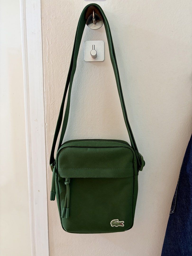 FS: Authentic Lacoste🐊 Neocroc Vertical Camera Bag ~ Green (Category: Cross-body Bags) located in Quezon City. Submitted by baessist_z (Listing ID 1463380922, Image 3). Description: FS: Authentic Lacoste🐊 Neocroc Vertical Camera Bag. Price : Php 2.5k Color : Green Condition : Used - Authentic Lacoste green canvas crossbody bag - Features a convenient front pocket with a stylish drawstring detail - Adjustable strap for a comfortable, customized 