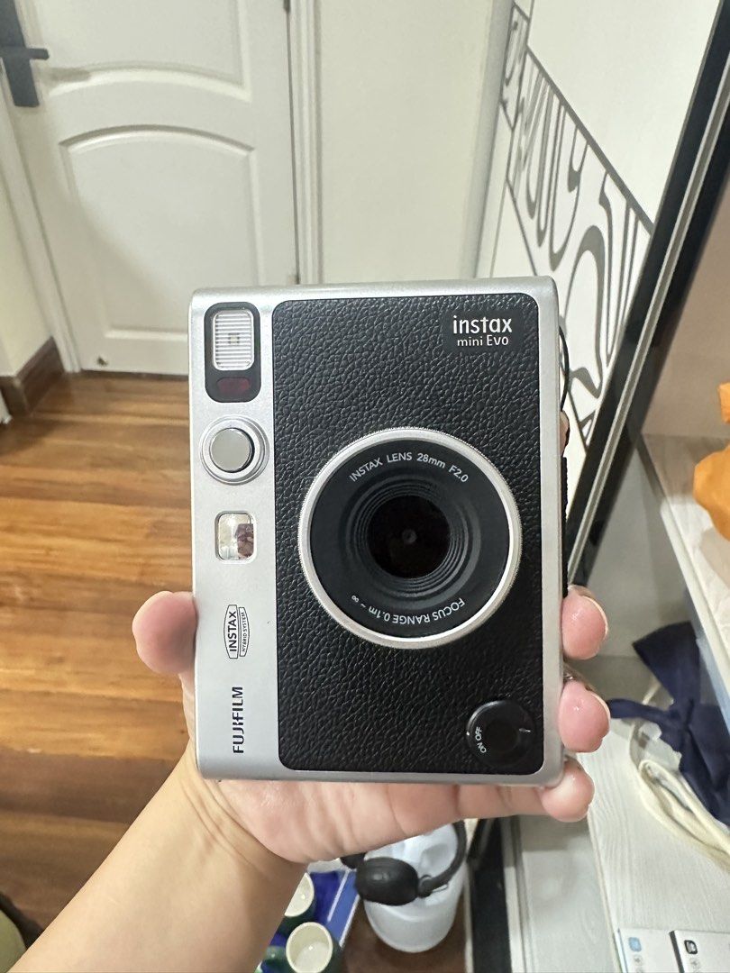 Fujifilm Instax Mini Evo Hybrid Instant Camera (Category: Cameras) located in San Juan City. Submitted by rose.lucky (Listing ID 1463440650, Image 2). Description: - Fujifilm Instax Mini Evo hybrid instant camera - Color: Black and Silver - Lens: Instax Lens 28mm F2.0 - Focus Range: 0.1m to infinity - Comes with original box - Perfect for capturing memories.