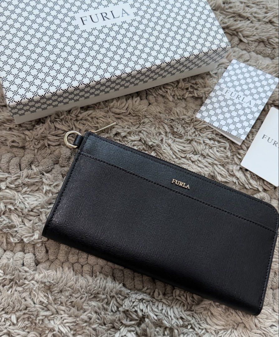 Furla Long Zip Wallet (Category: Luxury Bags & Wallets) located in Quezon City. Submitted by declutteringcloset18 (Listing ID 1463473529, Image 3). Description: Barely used! Black leather w/ gold hardware With tag, card and box Retails ~10k++ .
