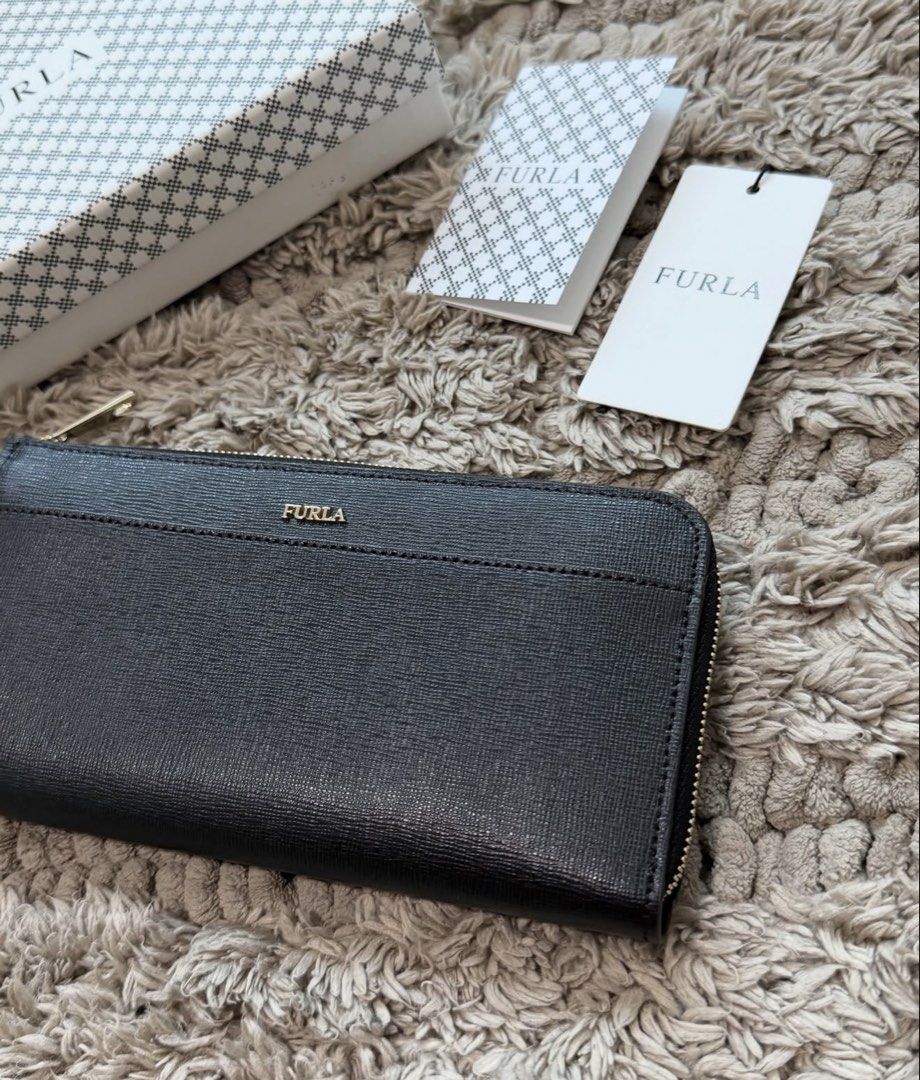 Furla Long Zip Wallet (Category: Luxury Bags & Wallets) located in Quezon City. Submitted by declutteringcloset18 (Listing ID 1463473529, Image 2). Description: Barely used! Black leather w/ gold hardware With tag, card and box Retails ~10k++ .