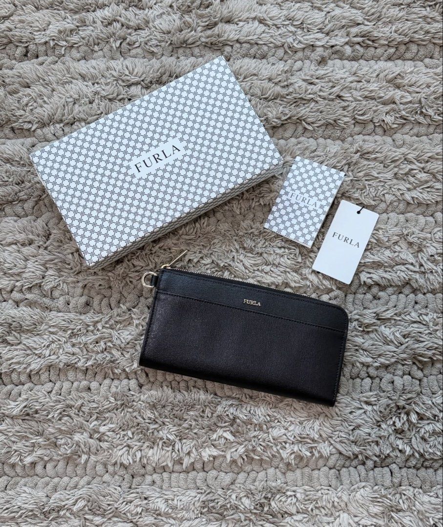 Furla Long Zip Wallet (Category: Luxury Bags & Wallets) located in Quezon City. Submitted by declutteringcloset18 (Listing ID 1463473529, Image 1). Description: Barely used! Black leather w/ gold hardware With tag, card and box Retails ~10k++ .