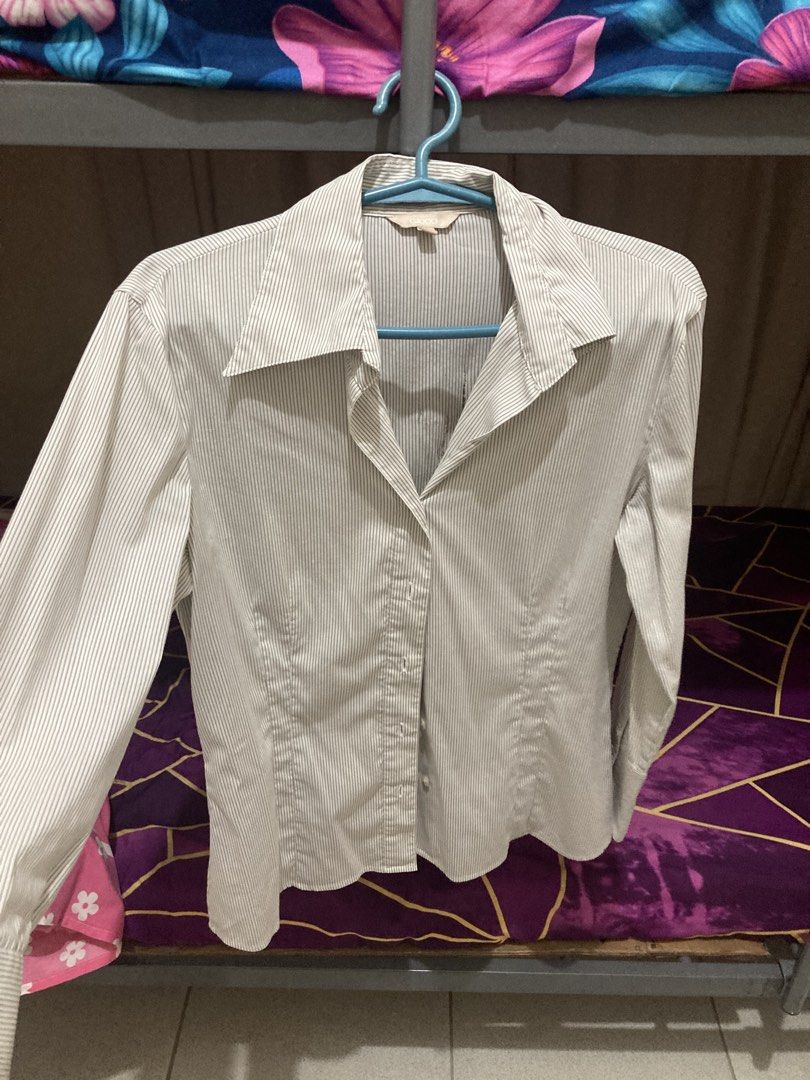 G2000 Striped Button-Up Shirt (Category: Longsleeves) located in Pasay City. Submitted by daisuki.x0x0 (Listing ID 1463447189, Image 1). Description: - G2000 long-sleeved button-up shirt - Features thin pinstripes - Classic button closure down the front - Cuffed sleeves - **Condition Note:** Small holes present on the front. Please review photos for detailed condition..