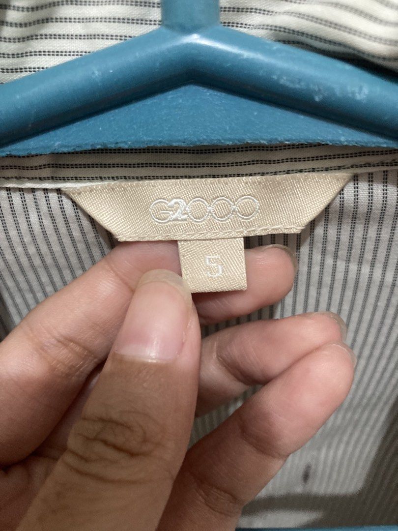 G2000 Striped Button-Up Shirt (Category: Longsleeves) located in Pasay City. Submitted by daisuki.x0x0 (Listing ID 1463447189, Image 3). Description: - G2000 long-sleeved button-up shirt - Features thin pinstripes - Classic button closure down the front - Cuffed sleeves - **Condition Note:** Small holes present on the front. Please review photos for detailed condition..
