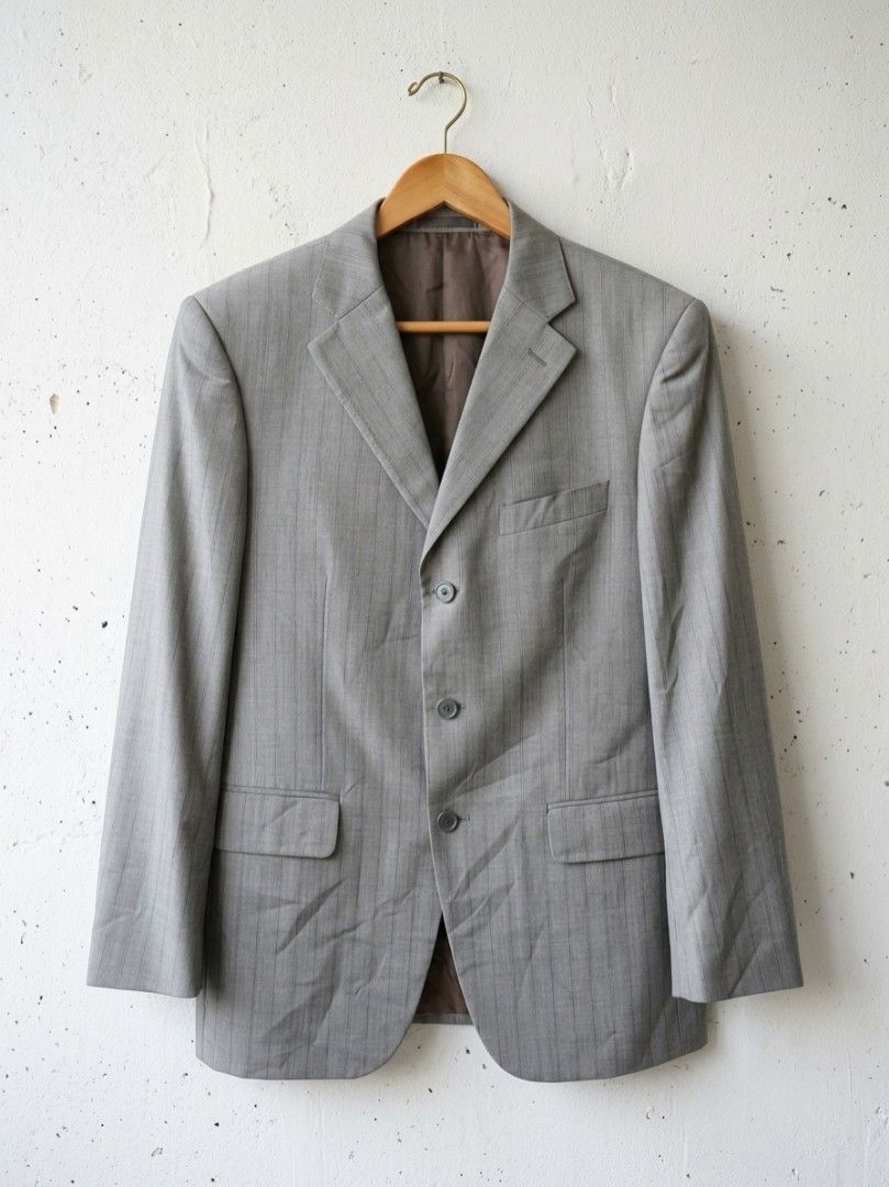 GIORGIO ARMANI LE COLLEZIONI blazer (Category: Coats, Jackets and Outerwear) located in Baguio. Submitted by luxeloomarchive (Listing ID 1463501146, Image 1). Description: This is a grey pinstripe suit jacket labeled "GIORGIO ARMANI LE COLLEZIONI". It has a vertical-line texture, a chest pocket, two front flap pockets, and three buttons. It appears to be vintage. ​Key product specifications: ​Size: 48 (EU/IT) ​Material: 55% wool, 25% polyester, 2