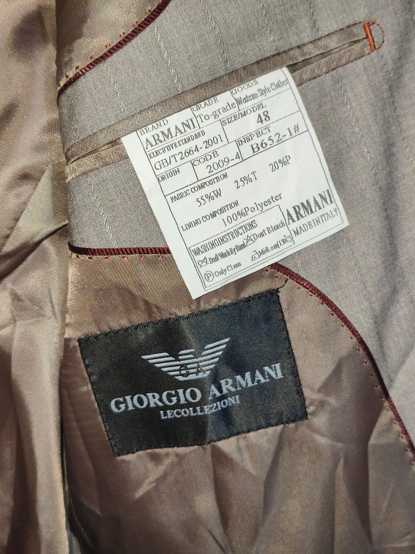 GIORGIO ARMANI LE COLLEZIONI blazer (Category: Coats, Jackets and Outerwear) located in Baguio. Submitted by luxeloomarchive (Listing ID 1463501146, Image 2). Description: This is a grey pinstripe suit jacket labeled "GIORGIO ARMANI LE COLLEZIONI". It has a vertical-line texture, a chest pocket, two front flap pockets, and three buttons. It appears to be vintage. ​Key product specifications: ​Size: 48 (EU/IT) ​Material: 55% wool, 25% polyester, 2