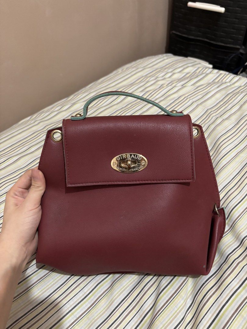 Girbaud Burgundy Handbag (Category: Luxury Bags & Wallets) located in Paranaque City. Submitted by mj.oha (Listing ID 1463393321, Image 2). Description: -Burgundy handbag with gold hardware. -Has a top handle and a flap closure. -Has a sling. -minor scratches.