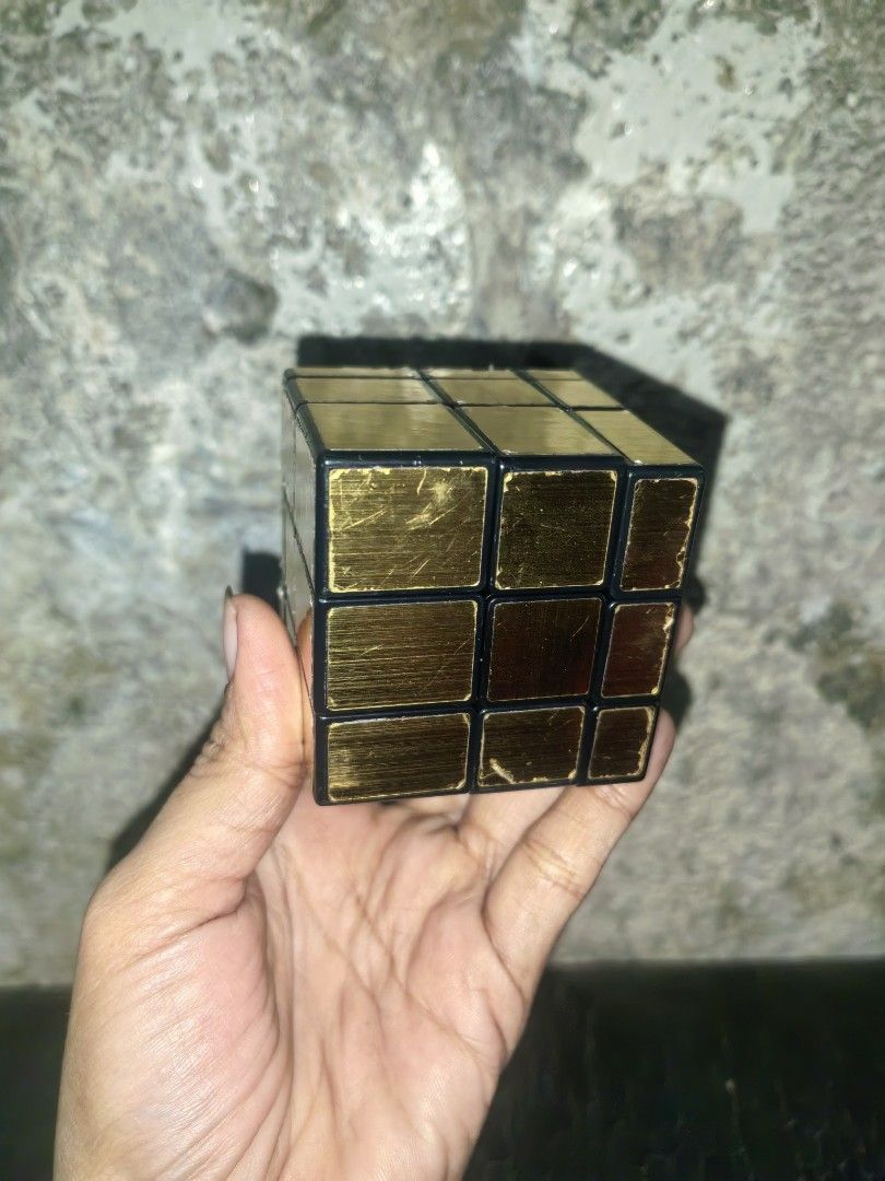 Gold Mirror Rubik's Cube 3x3 Puzzle Toy (Category: Board Games & Puzzles) located in Paranaque City. Submitted by furugiyafinds (Listing ID 1463469754, Image 1). Description: - Gold mirror finish Rubik's cube, resembles a 3x3 puzzle. - Still turns smoothly and functions perfectly as a puzzle. - Offers a fun and challenging mental workout. - Ideal for passing time or exercising your brain..
