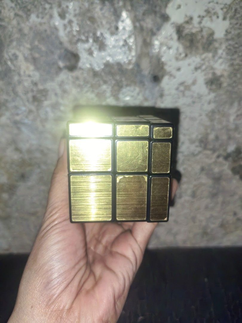 Gold Mirror Rubik's Cube 3x3 Puzzle Toy (Category: Board Games & Puzzles) located in Paranaque City. Submitted by furugiyafinds (Listing ID 1463469754, Image 2). Description: - Gold mirror finish Rubik's cube, resembles a 3x3 puzzle. - Still turns smoothly and functions perfectly as a puzzle. - Offers a fun and challenging mental workout. - Ideal for passing time or exercising your brain..