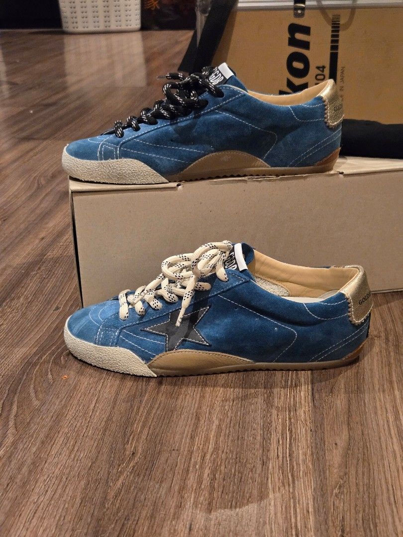 Golden Goose True Star BNEW GGDB (Category: Sneakers) located in Manila. Submitted by chocomoose (Listing ID 1463391417, Image 2). Description: Bnew in box. Size 38 Authentic. Bought in GG boutique in Greenbelt The True-Star features a soft teal suede upper, a white toe cap, and a black laminated leather star. A cream-coloured leather insert is positioned on the back, complemented by a platinum-foiled leather heel tab. The design includes two-ton