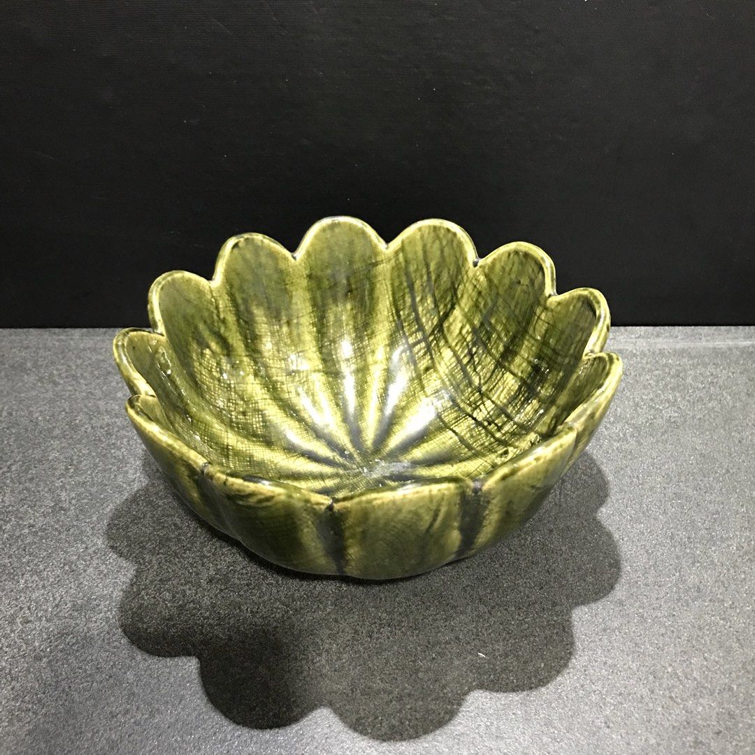 Green Ceramic Lotus Flower Shaped Serving Bowl (Category: Dinnerware & Cutlery) located in Baao. Submitted by all.things.japan (Listing ID 1463550599, Image 1). Description: 7.5 x 3.5 inches - Unique green ceramic bowl - Shaped like a lotus flower with scalloped edges - Ideal for serving snacks, dips, or as a decorative piece - Features a textured glaze finish - Dimensions: Approx. 7 inches across, 3 inches deep - Adds a vibrant pop of color to y