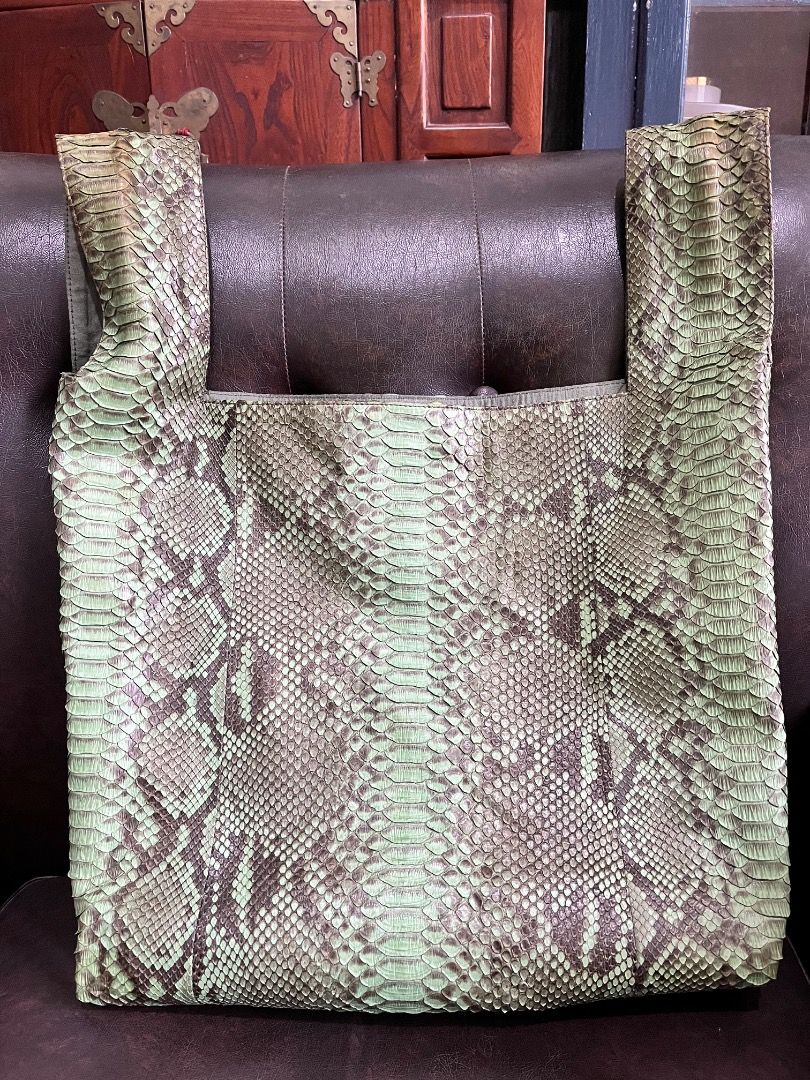 Green Snakeskin Print Foldover Bag (Category: Clutches) located in Makati City. Submitted by Ina_Ndang (Listing ID 1463473531, Image 2). Description: - Genuine snakeskin leather bag - This is a sando bag style with two integrated loop handles - The color is more of sage green with grayish and black combination - Can be used as foldable bag - With 1 open pocket inside; light green fabric lining - Perfect for elevating any outfit. Very unique and s