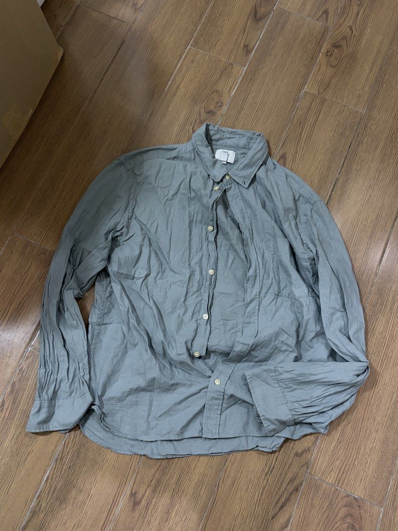 Grey Long Sleeve Button Up Shirt (Category: Tshirts & Polo Shirts ) located in Manila. Submitted by rich028 (Listing ID 1463521412, Image 1). Description: - Grey long sleeve button-up shirt - Classic collar with button closure - Slightly crinkled fabric texture - Comfortable for everyday wear - Versatile for casual outfits or layering.