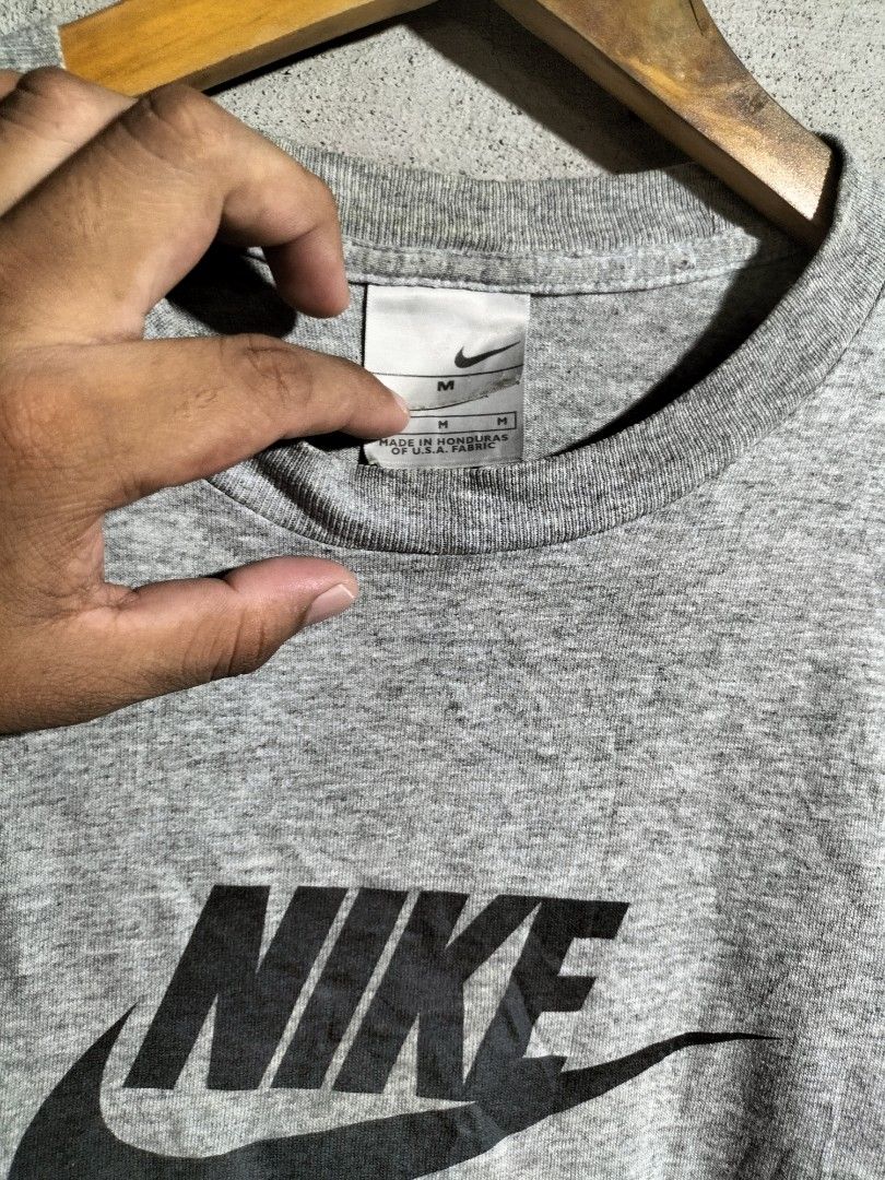 Grey Nike T-shirt Size M (Category: Tshirts & Polo Shirts ) located in Valencia. Submitted by cabisaythriftshop (Listing ID 1463419897, Image 2). Description: - Classic grey Nike t-shirt - Features the iconic Nike logo on the front - Made in Honduras from U.S.A. fabric - Size Medium - Great for everyday wear.