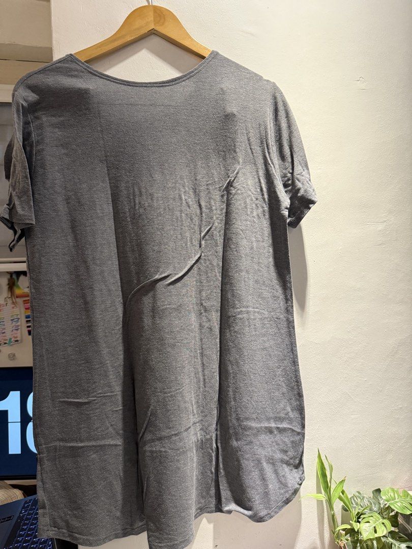 Grey T-shirt with Curved Hem (Category: Blouses) located in Manila. Submitted by jicka (Listing ID 1463328794, Image 2). Description: - Classic grey t-shirt - Short sleeves - Curved hemline, longer at the back - Simple and versatile design - Perfect for layering or wearing alone - Effortlessly matches any wardrobe - Bought for ₱200. Selling for ₱39.