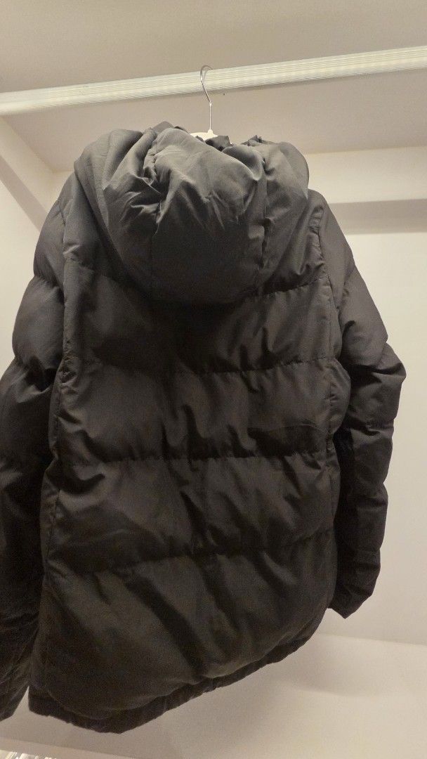 GU Black Puffer Jacket with Hood (Category: Coats, Jackets and Outerwear) located in Mandaluyong City. Submitted by loijiminigo (Listing ID 1463455083, Image 2). Description: - GU Black Puffer Jacket - Zip-away hood for versatility - Adjustable drawstring waist and hem - Secure zipper and snap button closure - Made with 100% Polyester (shell, lining, and filling) - Excellent for staying warm and cozy.