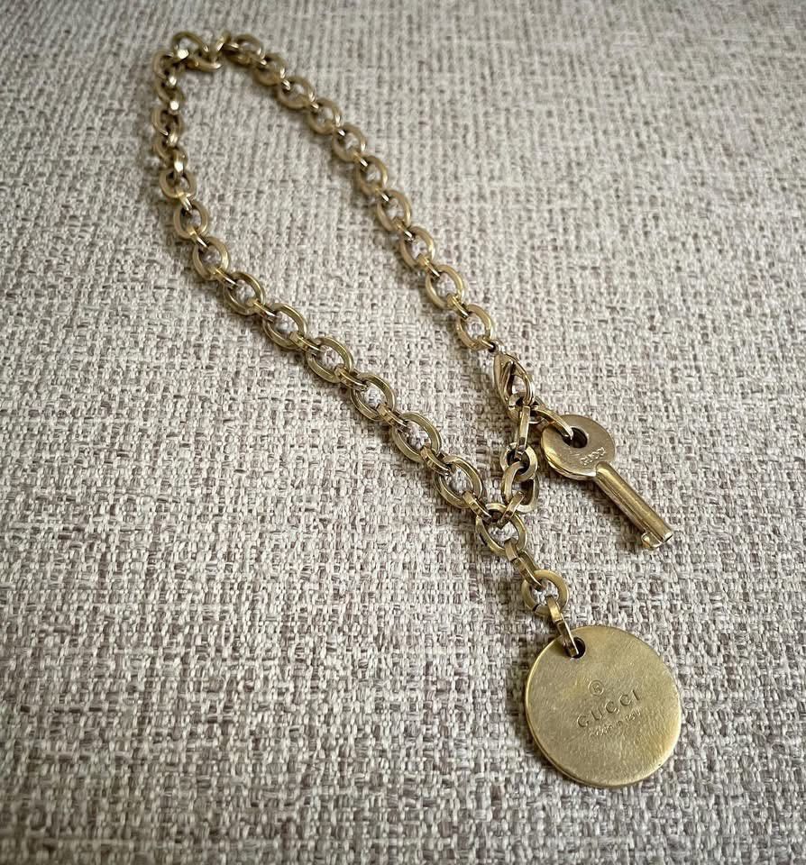 Gucci Keychain with Key and Charm (Category: Charms) located in Bulacan. Submitted by thriftbagcollections (Listing ID 1463442910, Image 1). Description: - Authentic Gucci keychain - Features iconic Gucci logo on round charm and key - Gold-toned metal - Great accessory for bags or keys.