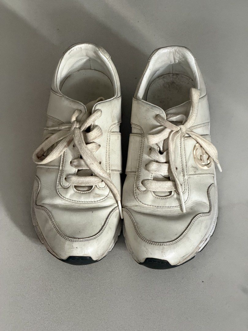 Gucci White Leather Sneakers (Category: Sneakers) located in Taguig. Submitted by anxmz (Listing ID 1463408352, Image 1). Description: - Authentic white leather Gucci sneakers - Features the iconic GG logo on the side - Laces are slightly worn - Soles have some dirt - Interior shows some marks - Overall, a great pair of stylish kicks.
