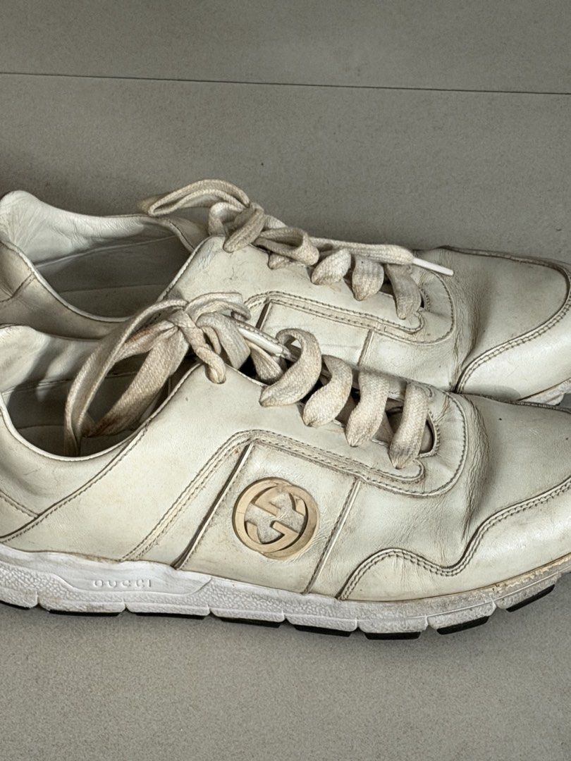 Gucci White Leather Sneakers (Category: Sneakers) located in Taguig. Submitted by anxmz (Listing ID 1463408352, Image 2). Description: - Authentic white leather Gucci sneakers - Features the iconic GG logo on the side - Laces are slightly worn - Soles have some dirt - Interior shows some marks - Overall, a great pair of stylish kicks.