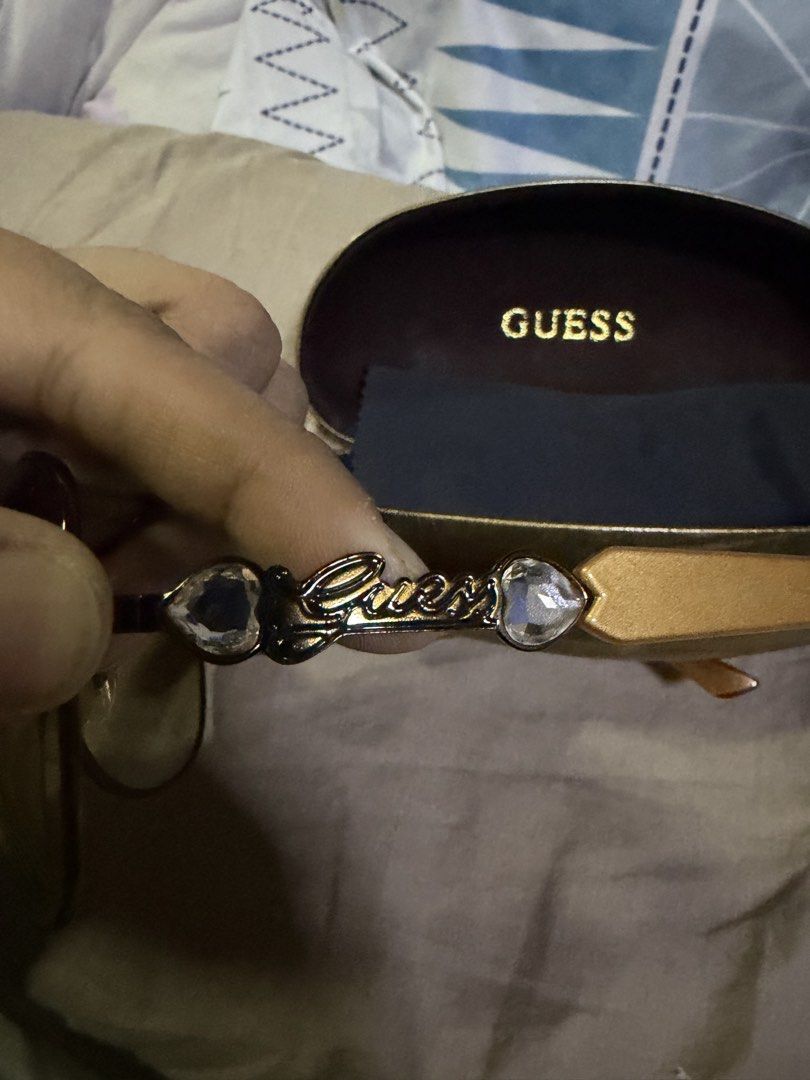 Guess Aviator Sunglasses with Case (Category: Sunglasses & Eyewear) located in Pasig City. Submitted by aprilluxcloset0812 (Listing ID 1463480278, Image 3). Description: - Guess aviator sunglasses - Dark lenses with subtle gradient - Arms with wood-like finish - Guess logo with heart-shaped accents on arms - Original hard case included RFS: decluttering EVERYTHING MUST GO‼️Just make a reasonable offer ❤️ All items ON HAND, handled with love, read