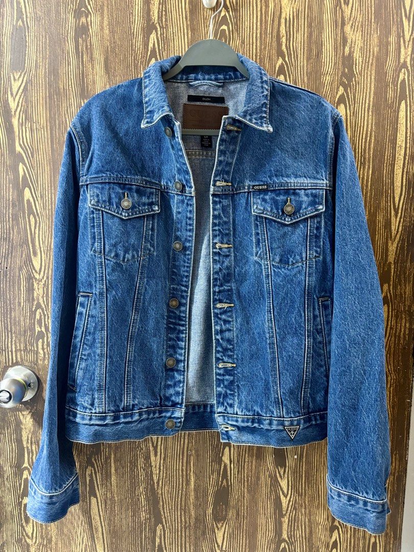 GUESS Denim Jacket (Category: Coats, Jackets and Outerwear) located in Makati City. Submitted by closet_by_mka (Listing ID 1463518655, Image 1). Description: GUESS Denim Jacket 💙 Never worn ✨ Super good condition! Classic denim jacket that’s easy to style and goes with pretty much everything 🤍 Sad to let this go but hoping it finds a new home! • Guess original denim jacket • Classic medium blue wash • Button-front closure • 2 chest pockets + si