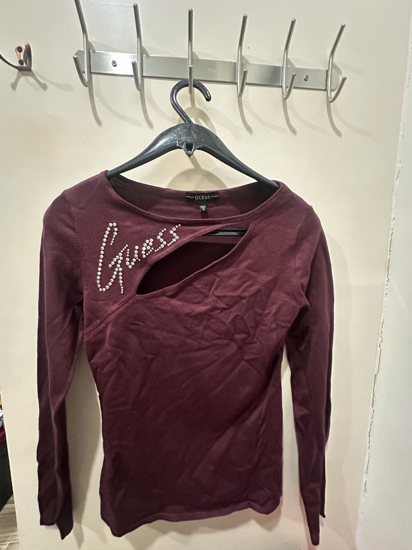 Guess Long Sleeve Top (Category: Longsleeves) located in Davao. Submitted by secondlife.authentic (Listing ID 1463461574, Image 1). Description: - Guess maroon long-sleeved top - Features Guess logo embellished with rhinestones - Neckline cut-out detail - Versatile for night out or casual wear (Used Only Once).