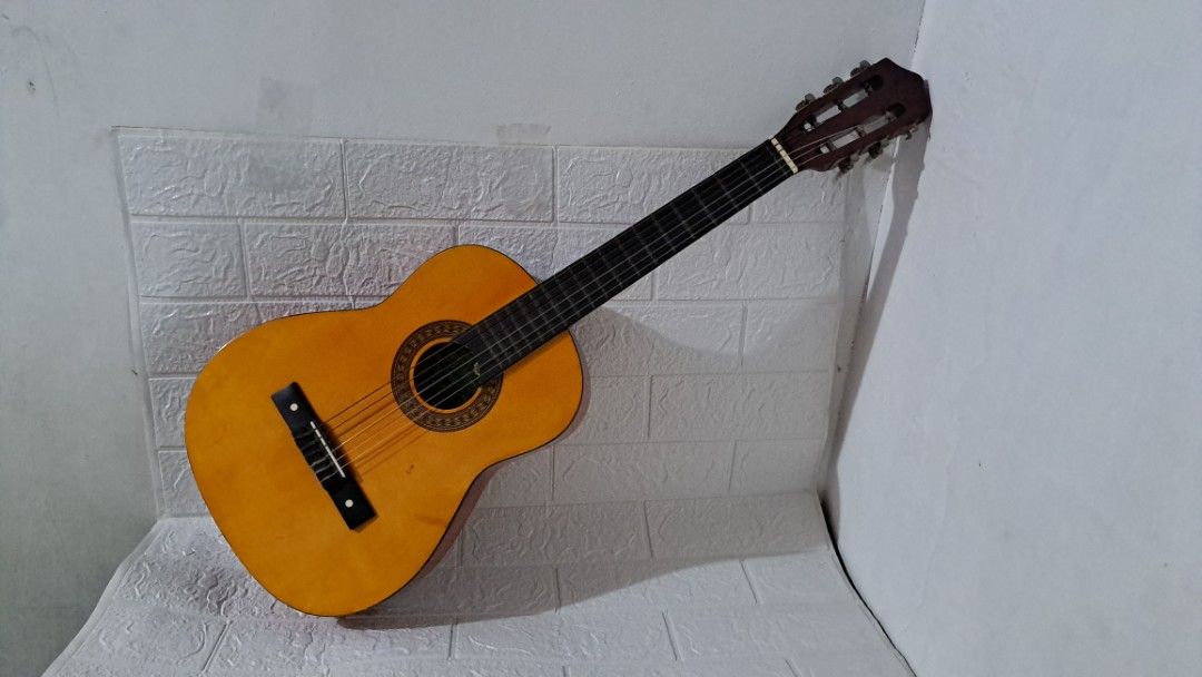 Guitar - Skylark MG Classical Guitar Natural (Category: Musical Instruments) located in Quezon City. Submitted by hersheejubilo (Listing ID 1463479252, Image 1). Description: Classical/nylon-string guitar • 6 strings • Small/compact body • Natural wood-tone finish • Shows some signs of use and minor scratches • Tuning keys and hardware show signs of age • Strings are old and may need replacement • Selling as-is 📌 Please check the photos carefull