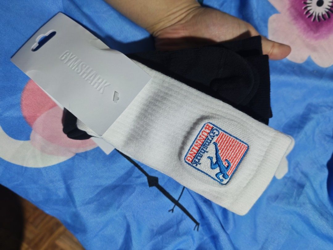 GYMSHARK RUNNING SOCKS 2 Pack (L) (Category: Socks) located in Las Pinas. Submitted by mojoejoejoe2 (Listing ID 1463478155, Image 2). Description: - 2-pack Gymshark running socks - Includes one black pair and one white pair - Both pairs feature graphic prints - Made with a comfortable blend of cotton, nylon, and elastane - Ideal for running, gym sessions, and everyday wear.